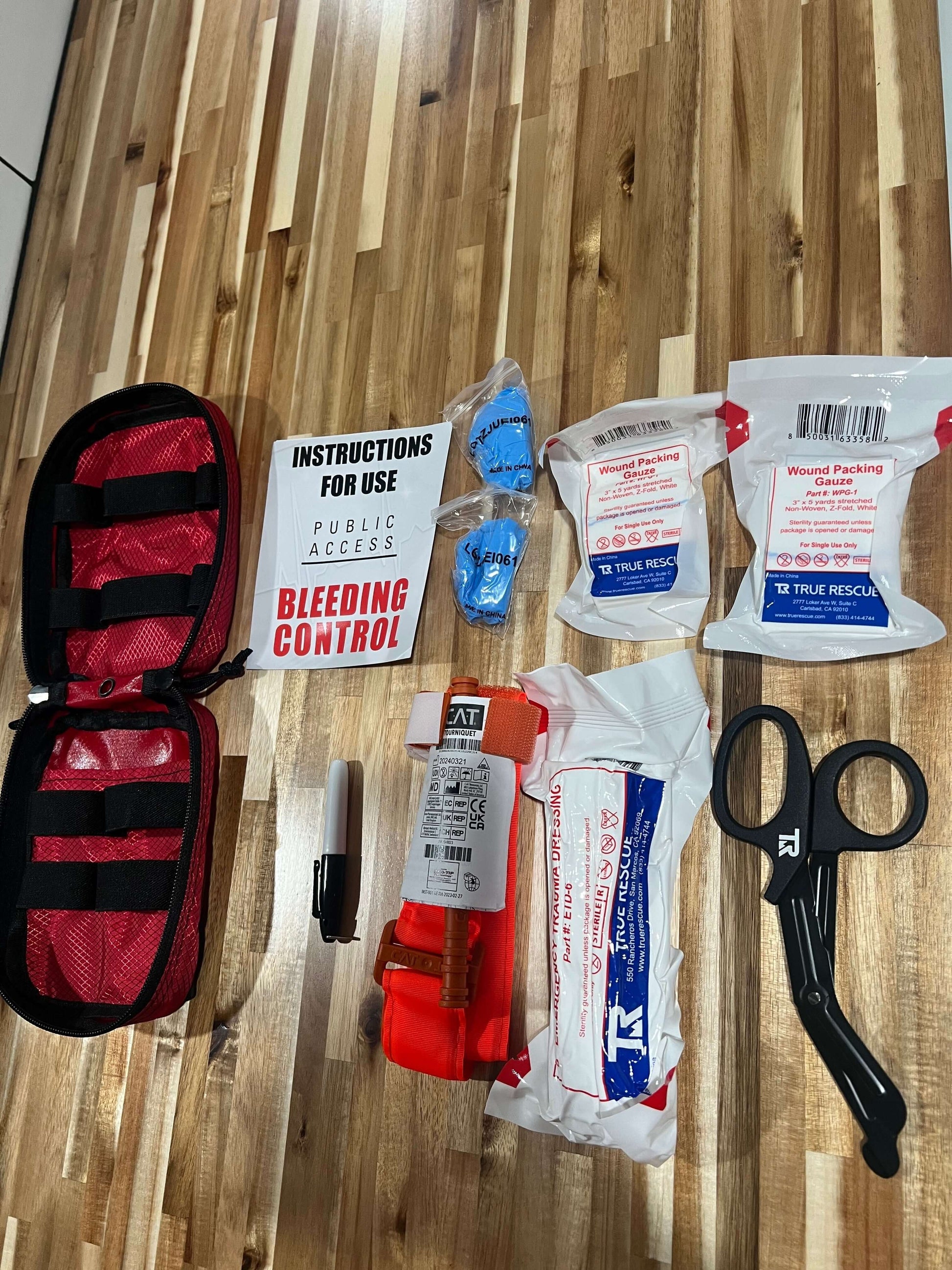 Portable bleeding control kit with tourniquet, bandages, and trauma supplies for schools and workplaces