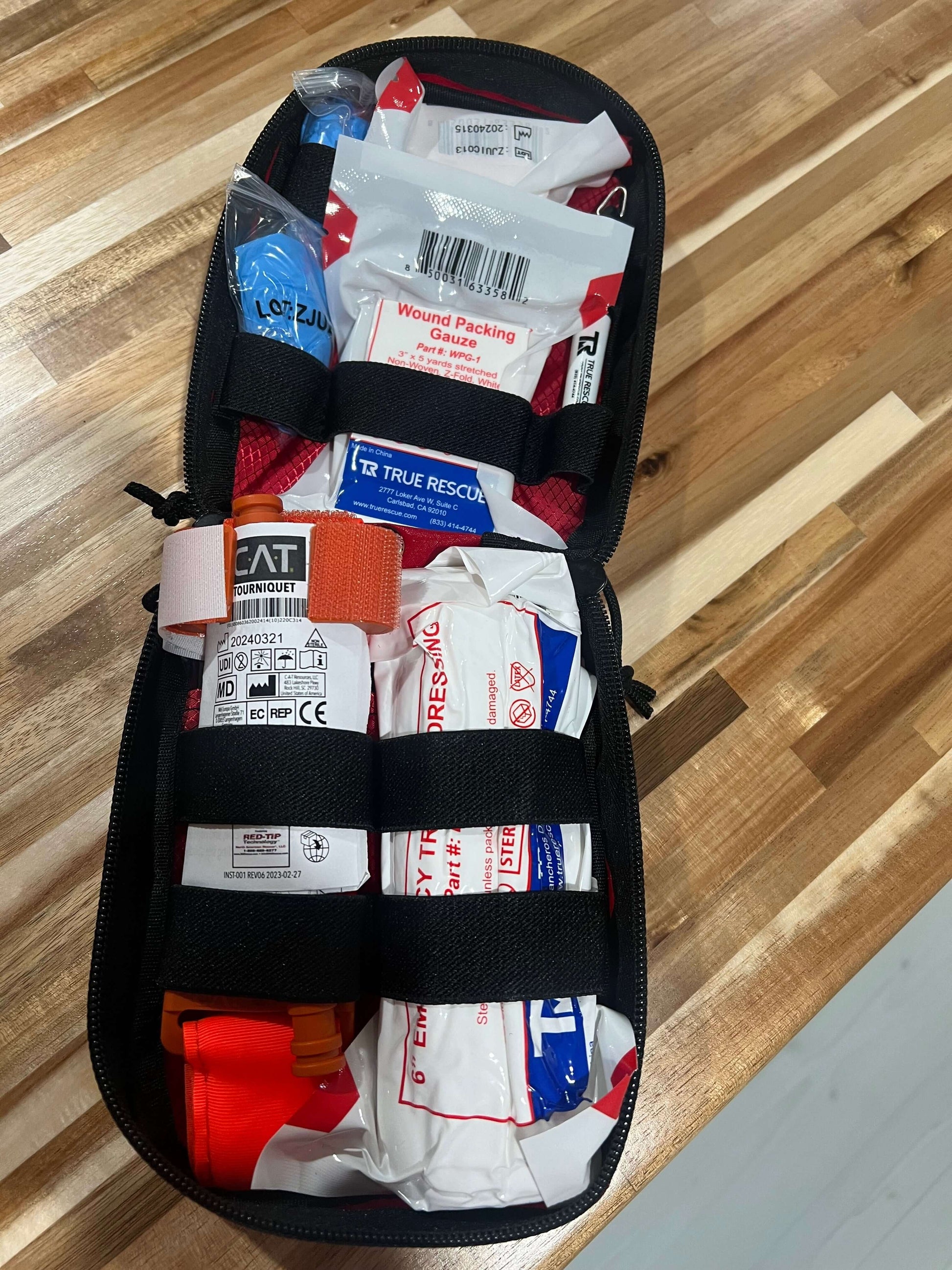 Portable bleeding control kit with tourniquet, bandages, and trauma supplies for schools and workplaces